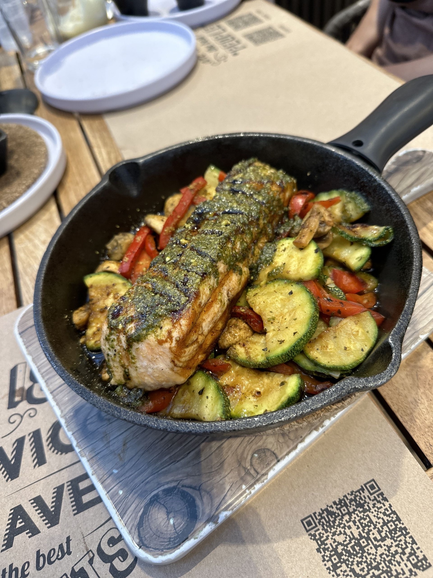 Grilled fish with pesto over zucchini and peppers